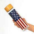 Land of Liberty glass water bottle with bamboo lid and patriotic star design